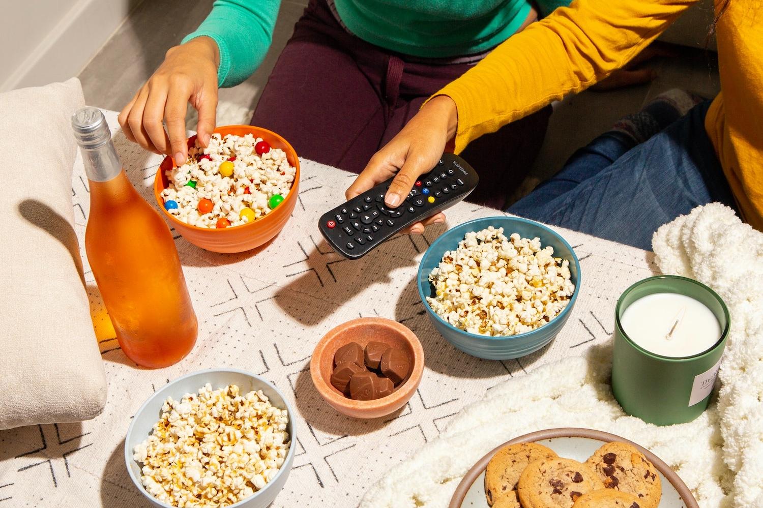 Two Friends Snacking and Watching Television